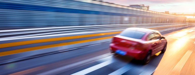 Car driving on freeway at sunset, motion blur full speed