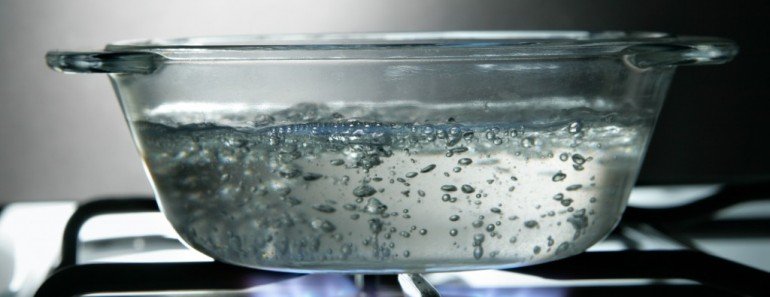 Boiling water in glass saucepan