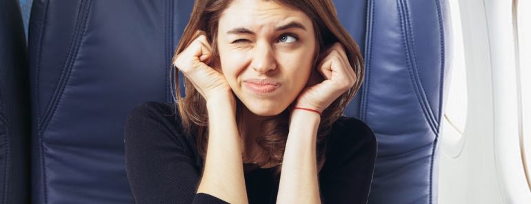 long-haired beautiful young brunette woman covering her ears with her hands, isolated on a white background