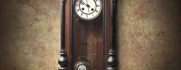 Old wooden pendulum hanging on a wall