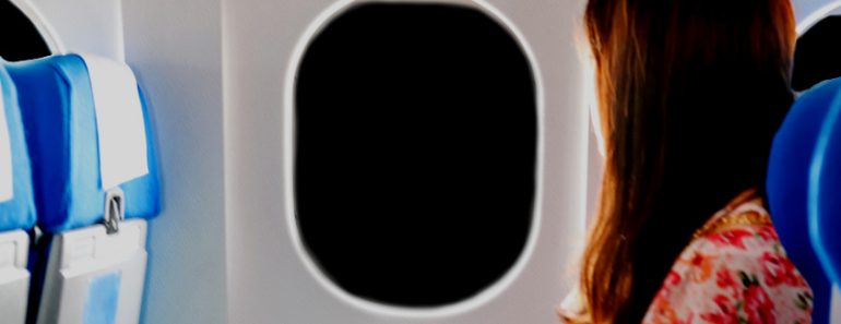 woman in airplane window night dark sky