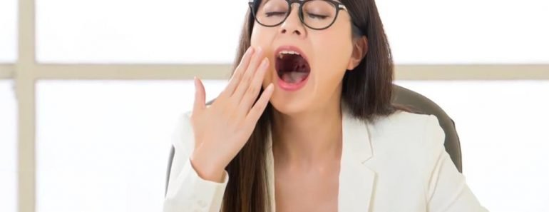 Yawning woman in office