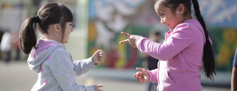 Two little girls playing Rock paper scissor playing children