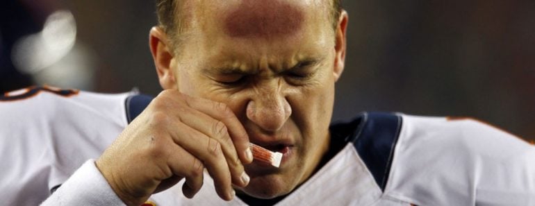 Denver Broncos quarterback Peyton Manning sniffs smelling salts