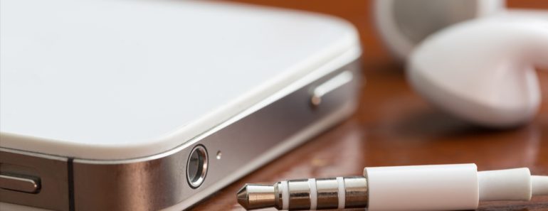 Close-up of a smartphone, earbuds, jack and port on a table with shallow depth of field - Image(David Smart)s