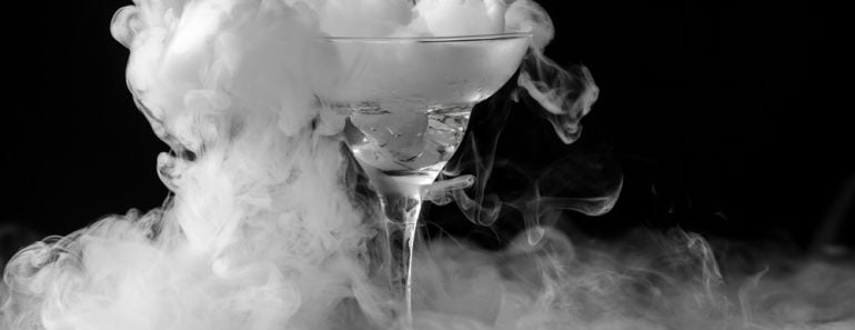 Closeup glass with white fog at dark background. Chemical reaction of dry ice with water. - Image( Andrei Mayatnik)s