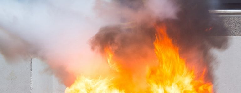 Instructor showing how to use a fire extinguisher on a training fire(sod tatong)s