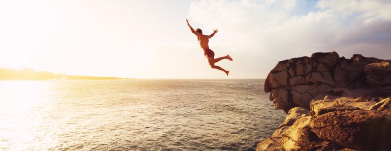 Cliff Jumping into the Ocean at Sunset(EpicStockMedia)S