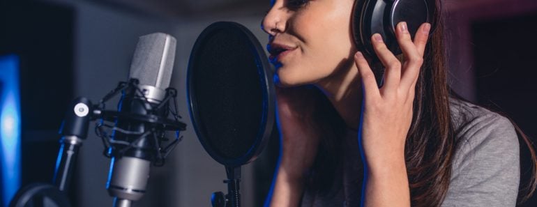 Close up of female vocal artist singing in a recording studio(Jacob Lund)s