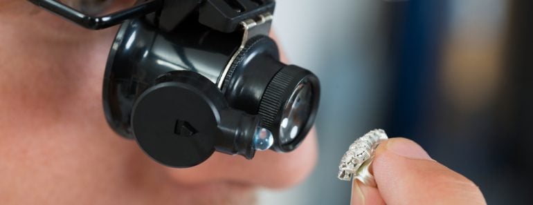 Close-up Of Jeweler Looking Ring Through Magnifying Loupe(Andrey_Popov)S