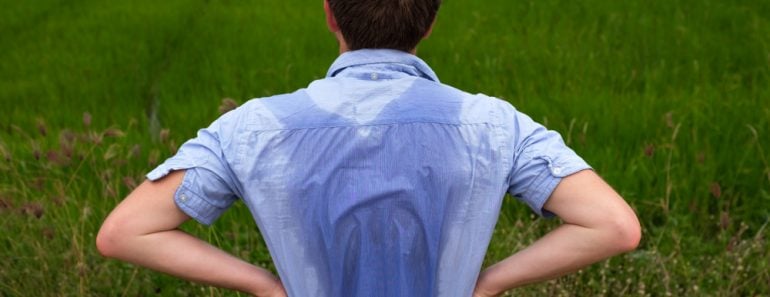 Man with hyperhidrosis sweating very badly under armpit in blue shirt because of hot weather(Koldunova Anna)s