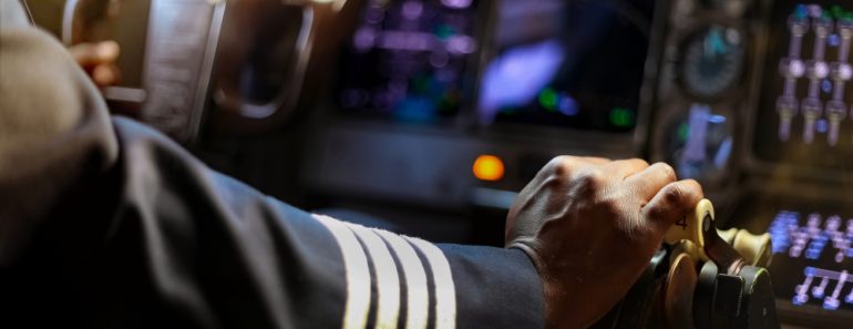 Cropped,Hands,Of,African,Pilot,Flying,A,Commercial,Airplane,,Cockpit